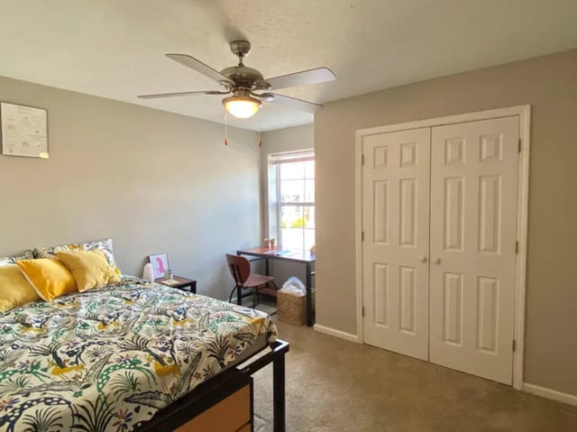 Bed desk closet and ceiling fan bedroom at 1909 Campus Flats in Bowling Green Student Accommodation