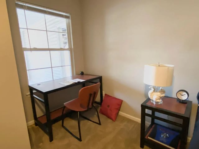 Desk chair pillow lamp and clock study area at 1909 Campus Flats in Bowling Green Student Accommodation