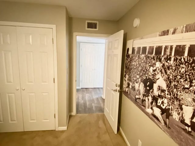 Closet doors open doorway football mural hallway interior at 1909 Campus Flats in Bowling Green Student Accommodation