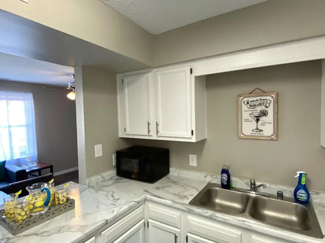 Kitchen with sink microwave and margarita sign kitchen at 1909 Campus Flats in Bowling Green Student Accommodation