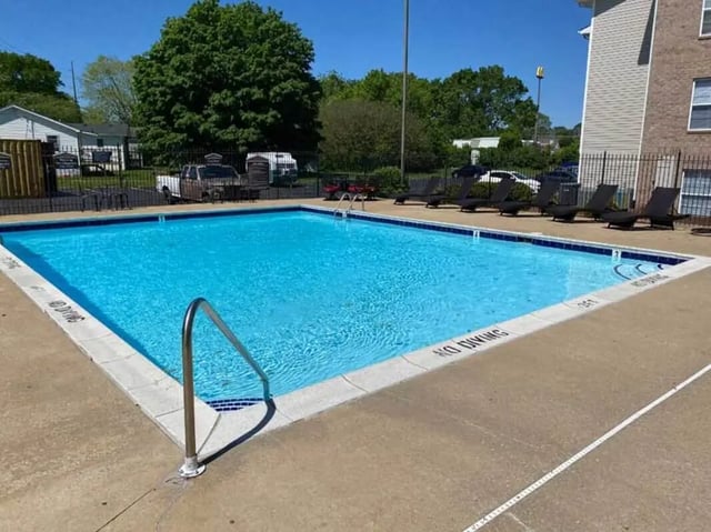 Rectangular pool with loungers and metal railings swimming area at 1909 Campus Flats in Bowling Green Student Accommodation