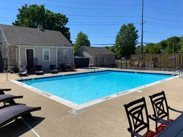 Pool with lounge chairs and seating area exterior at 1909 Campus Flats in Bowling Green Student Accommodation