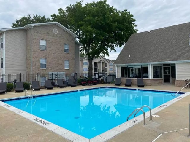 Swimming pool with lounge chairs exterior at 1909 Campus Flats in Bowling Green Student Accommodation