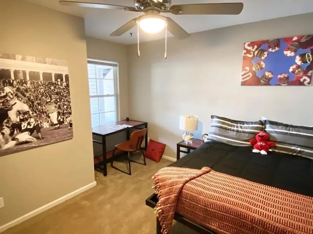 Bed desk chair rug football art bedroom at 1909 Campus Flats in Bowling Green Student Accommodation