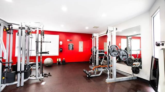 Weight machines and barbells gym equipment playing area at 1909 Campus Flats in Bowling Green Student Accommodation