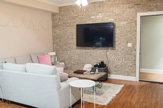 Sofa TV coffee table and rug living room at 607 South Oxford Apartments in Oxford Student Accommodation