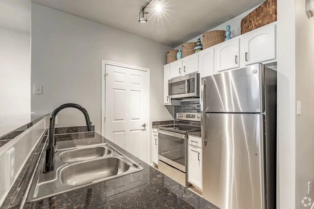 Stainless steel appliances granite countertops kitchen at Heron on Hausman in San Antonio Student Accommodation