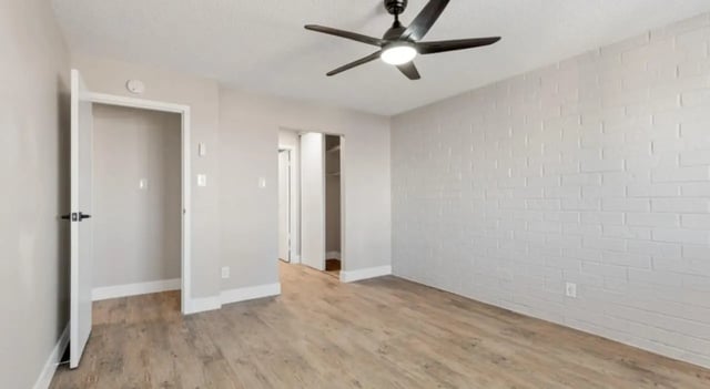 Empty room with ceiling fan and doors bedroom at Mint Urban Infinity in Denver Student Accommodation