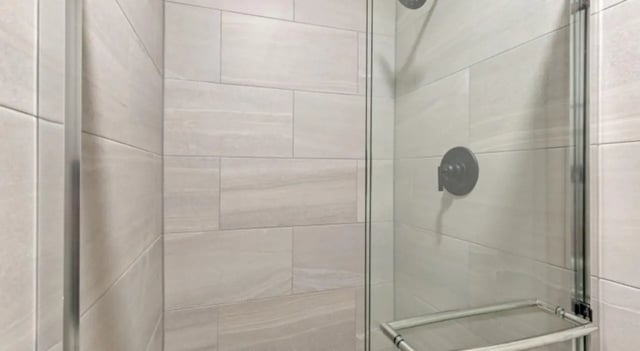Tiled shower stall with glass door bathroom at Mint Urban Infinity in Denver Student Accommodation