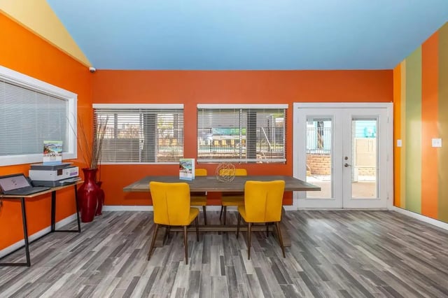 Dining table with yellow chairs study area at Villas De La Plaza in Austin Student Accommodation