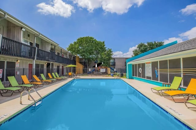 Swimming pool lounge chairs and playground exterior at Villas De Sendero in San Antonio Student Accommodation
