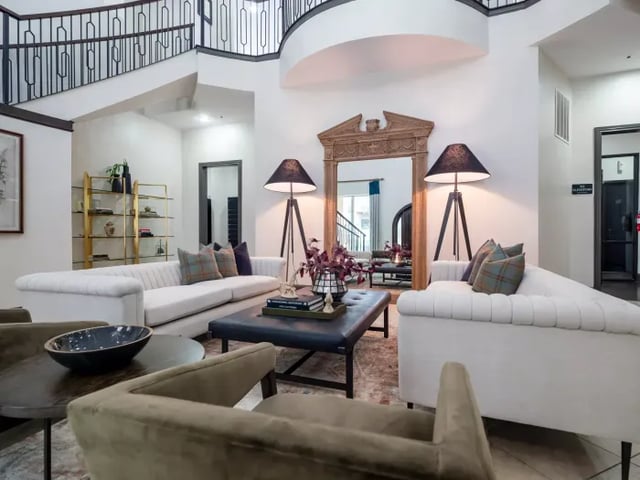 White sofas ornate mirror sectional lounge living room at Vines at Turtle Creek in Dallas Student Accommodation