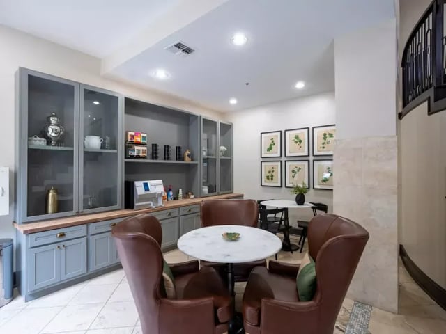 Leather chairs white table coffee station lounge area at Vines at Turtle Creek in Dallas Student Accommodation
