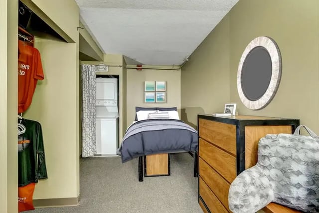 Bed dresser mirror and laundry bedroom at Dwell The Towers on State in Madison Student Accommodation