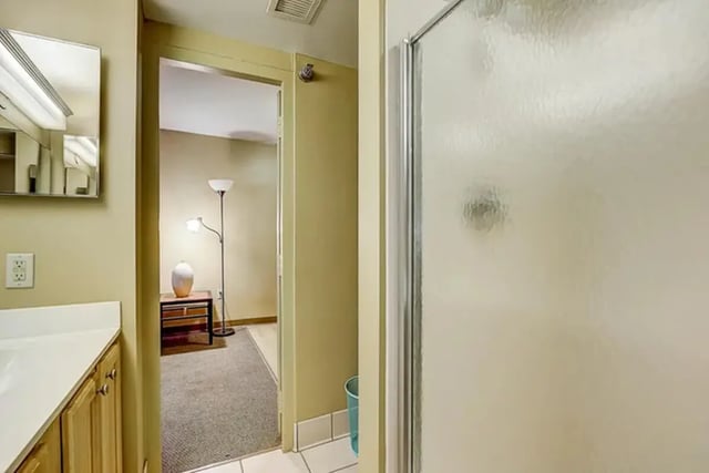 Frosted shower door vanity and vase bathroom at Dwell The Towers on State in Madison Student Accommodation