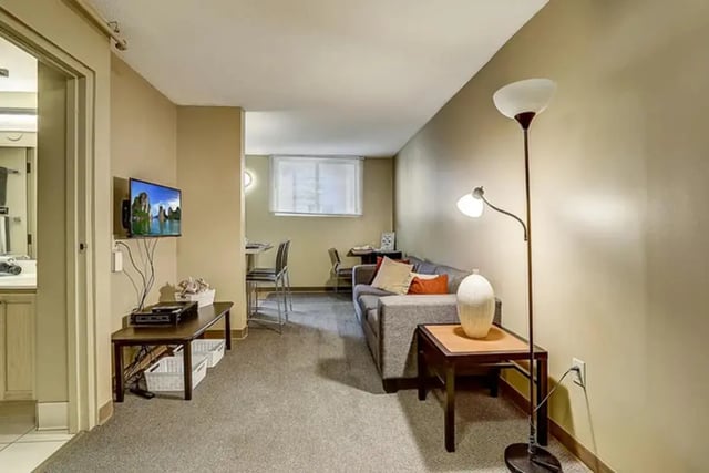 Couch television table with baskets living room at Dwell The Towers on State in Madison Student Accommodation