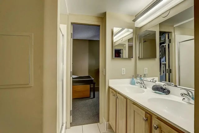 Double sink vanity with towels reflected in mirror Bathroom at Dwell The Towers on State in Madison Student Accommodation