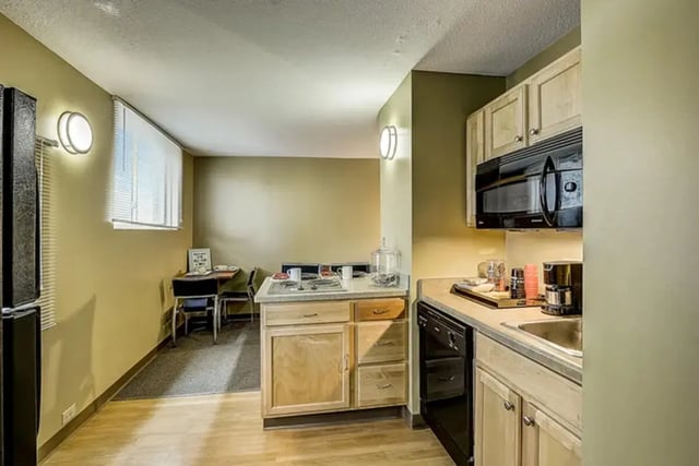 Kitchen with refrigerator stove sink cabinets and dining area kitchen at Dwell The Towers on State in Madison Student Accommodation