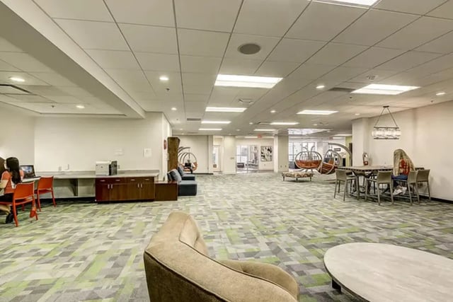 Study area with tables chairs and lounge furniture communal space at Dwell The Towers on State in Madison Student Accommodation