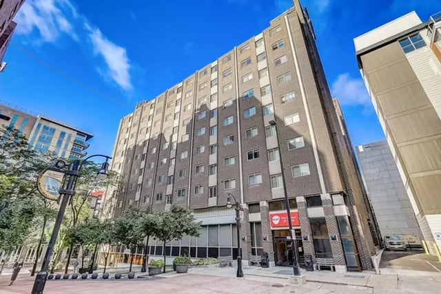 Tall brick building with many windows exterior at Dwell The Towers on State in Madison Student Accommodation