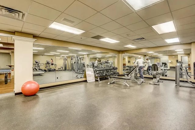 Gym equipment with weights and treadmills Gym at Dwell The Towers on State in Madison Student Accommodation