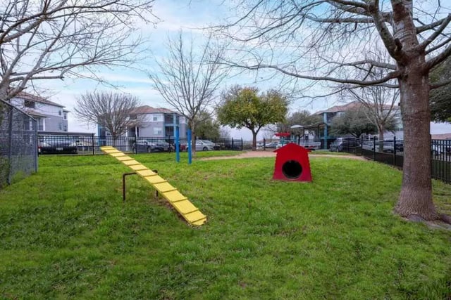 Red dog house yellow agility ramp dog park at Cabana Beach San Marcos in San Marcos Student Accommodation