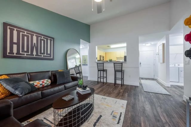 Brown leather couch with pillows and coffee table living room at Cabana Beach San Marcos in San Marcos Student Accommodation