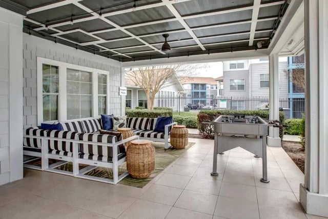 Striped sofas foosball table outdoor lounge at Cabana Beach San Marcos in San Marcos Student Accommodation