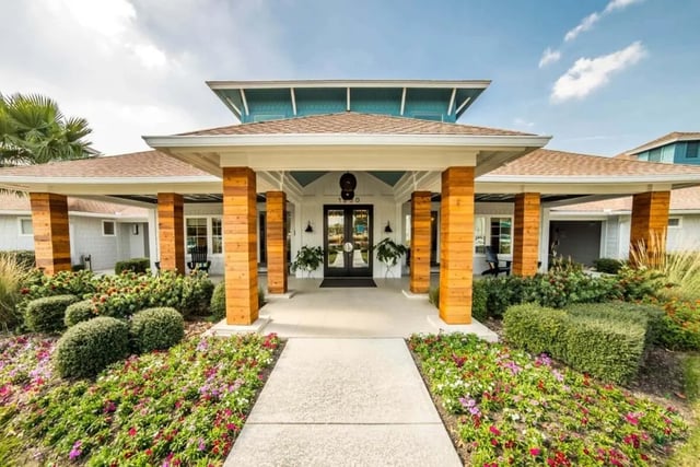 Building entrance with planters and colorful flowers exterior at Cabana Beach San Marcos in San Marcos Student Accommodation