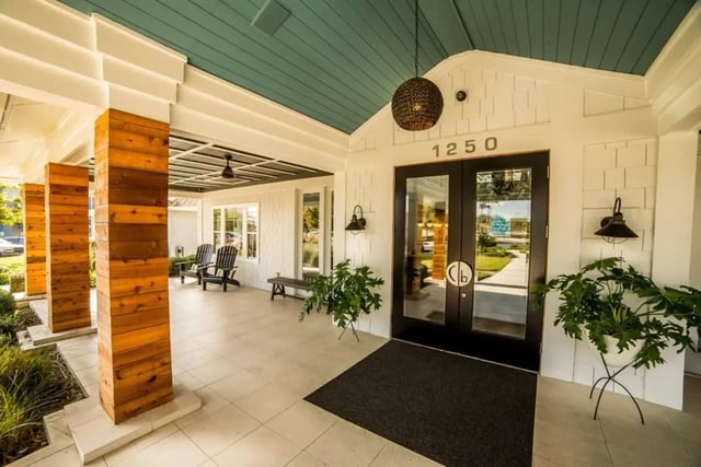 Porch with chairs bench plants and double doors exterior at Cabana Beach San Marcos in San Marcos Student Accommodation