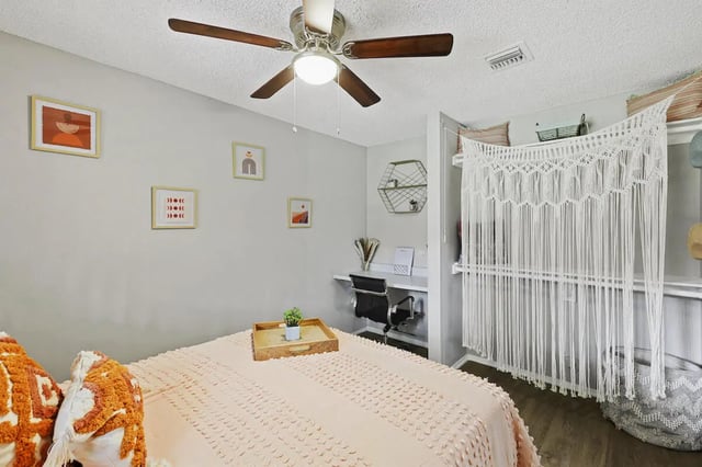 Bed with desk and macrame curtain bedroom at University Village Fullerton in Fullerton Student Accommodation