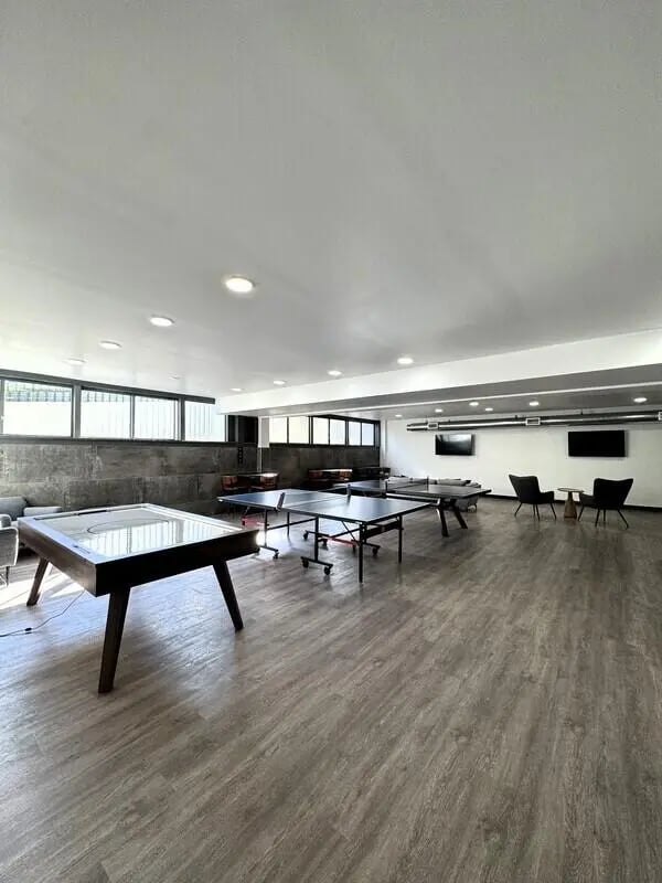 Air hockey table ping pong tables chairs lounge at University Village Fullerton in Fullerton Student Accommodation