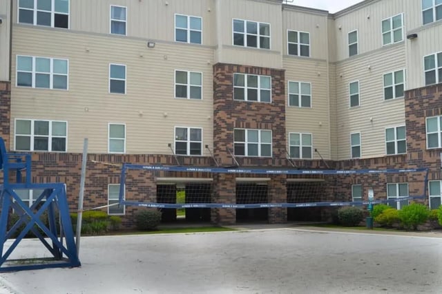 Building with volleyball court and net exterior at Varsity House Gainesville in Gainesville Student Accommodation