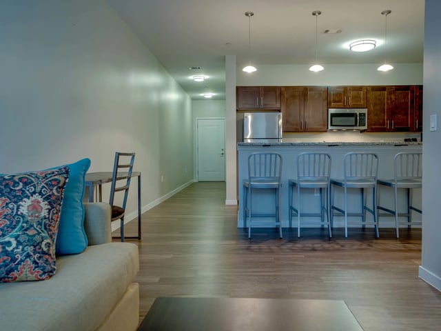 Sofa chairs kitchen island bar stools living room at College and Crown in New Haven Student Accommodation