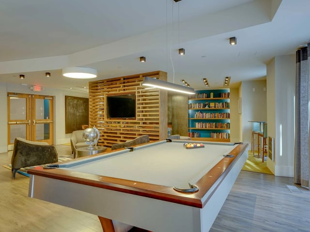 Pool table bookshelf and seating recreation area at College and Crown in New Haven Student Accommodation