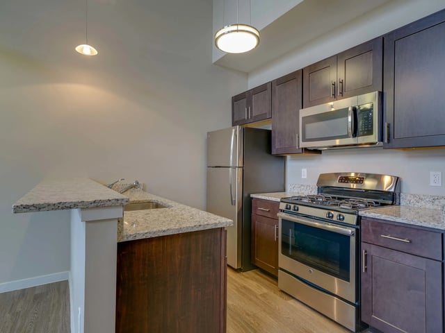 Stainless steel appliances and granite countertops kitchen at College and Crown in New Haven Student Accommodation