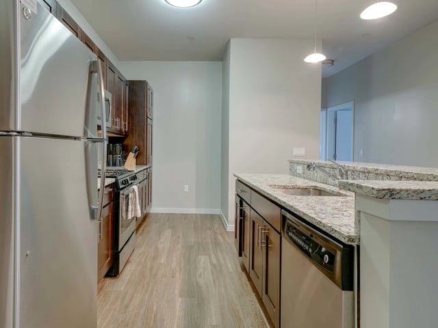 Modern kitchen with stainless steel appliances and cabinets Kitchen at College and Crown in New Haven Student Accommodation