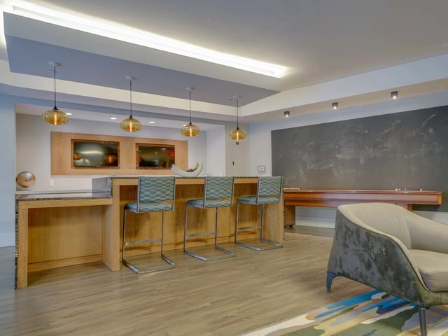 Bar with stools and pool table common area at College and Crown in New Haven Student Accommodation