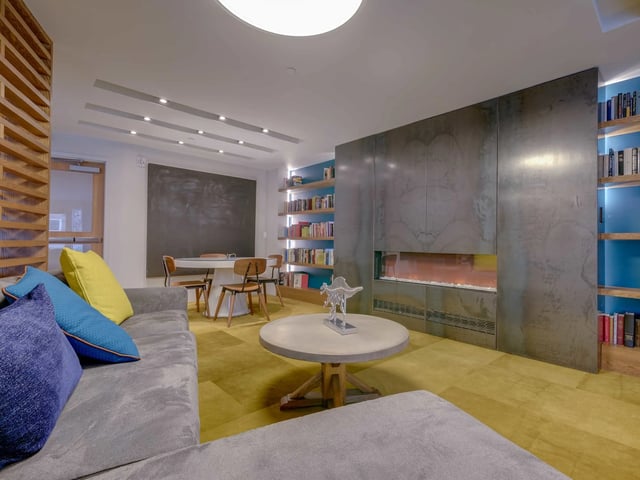 Sofa fireplace bookshelves table and chairs Living Room at College and Crown in New Haven Student Accommodation