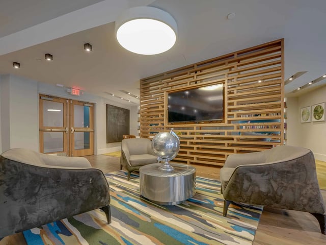 Chairs globe coffee table TV living room at College and Crown in New Haven Student Accommodation