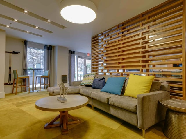 Sectional couch wood screen and coffee table living room at College and Crown in New Haven Student Accommodation
