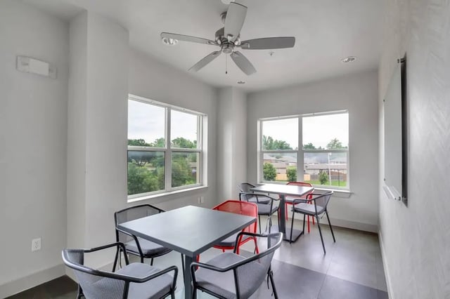 Tables chairs ceiling fan study area at Millennium in Norman Student Accommodation
