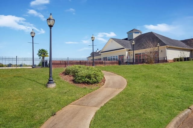 Path through green lawn to building exterior at The Arch Troy in Troy Student Accommodation