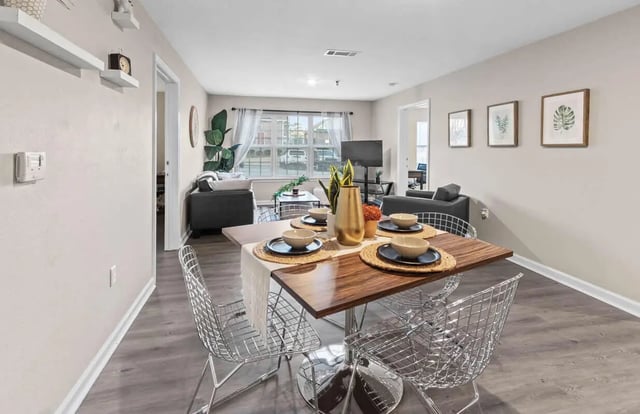 Dining table with chairs living room living room at Grove at Auburn in Auburn Student Accommodation