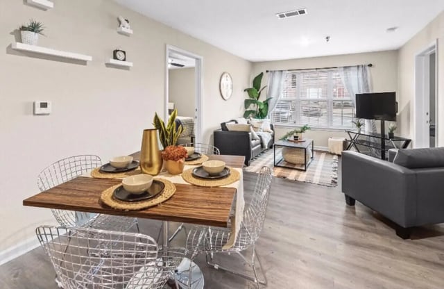 Dining table with chairs living room area living room at Grove at Auburn in Auburn Student Accommodation