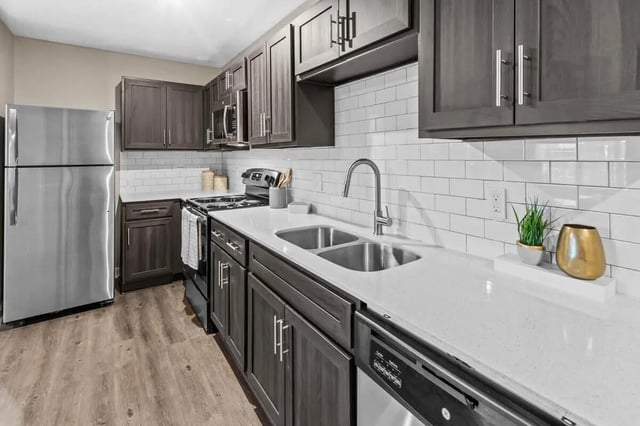 Modern kitchen with stainless steel appliances and dark cabinets kitchen at Grove at Auburn in Auburn Student Accommodation