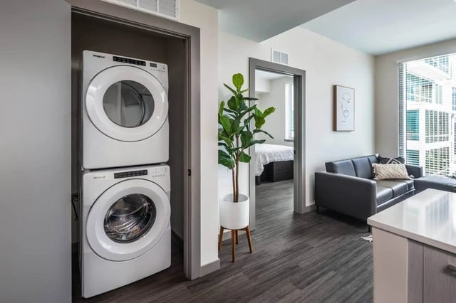 Stacked washer dryer sofa and plant living room exterior at The Henry in Tampa Student Accommodation