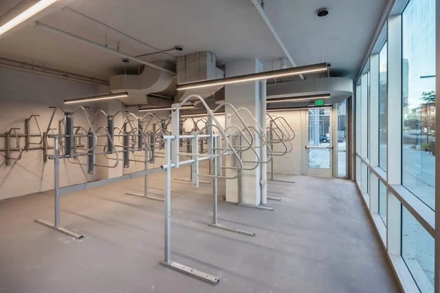 Empty bicycle racks inside a modern building interior exterior at The Henry in Tampa Student Accommodation
