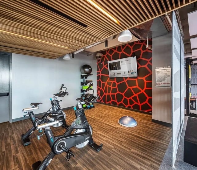 Two spin bikes yoga ball and TV playing area at The Henry in Tampa Student Accommodation