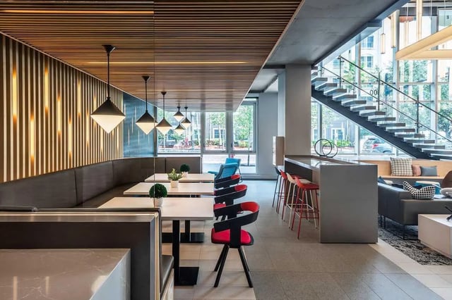 Banquette seating tables chairs counter stairs living area interior at The Henry in Tampa Student Accommodation